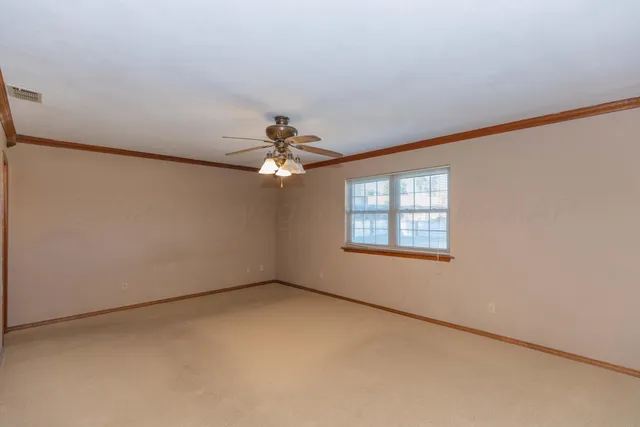 an empty room with a empty space and a ceiling fan