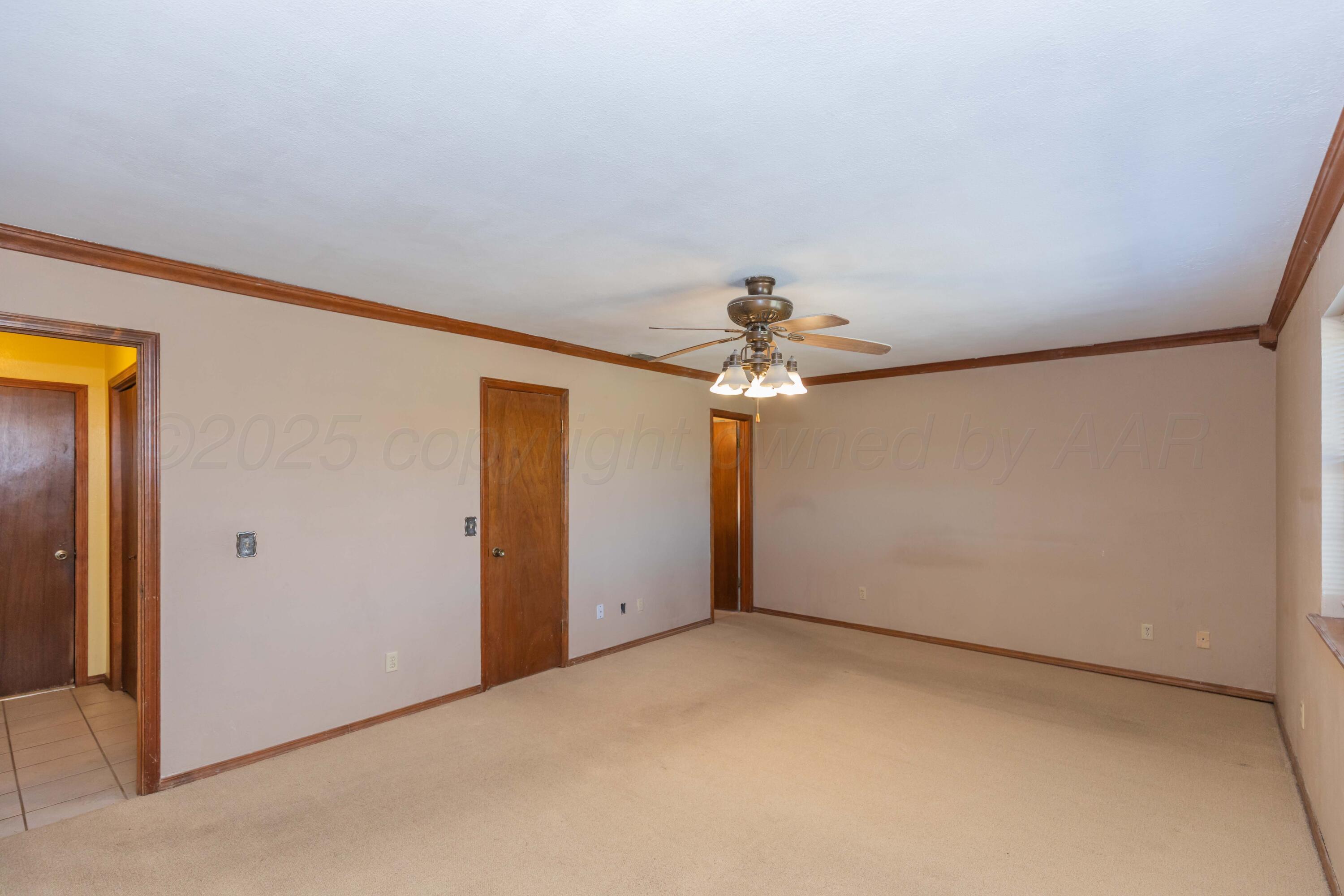 134 Eddie Street Canadian, TX 79014 - Photo 18 of 45 an empty room with a empty space and a ceiling fan