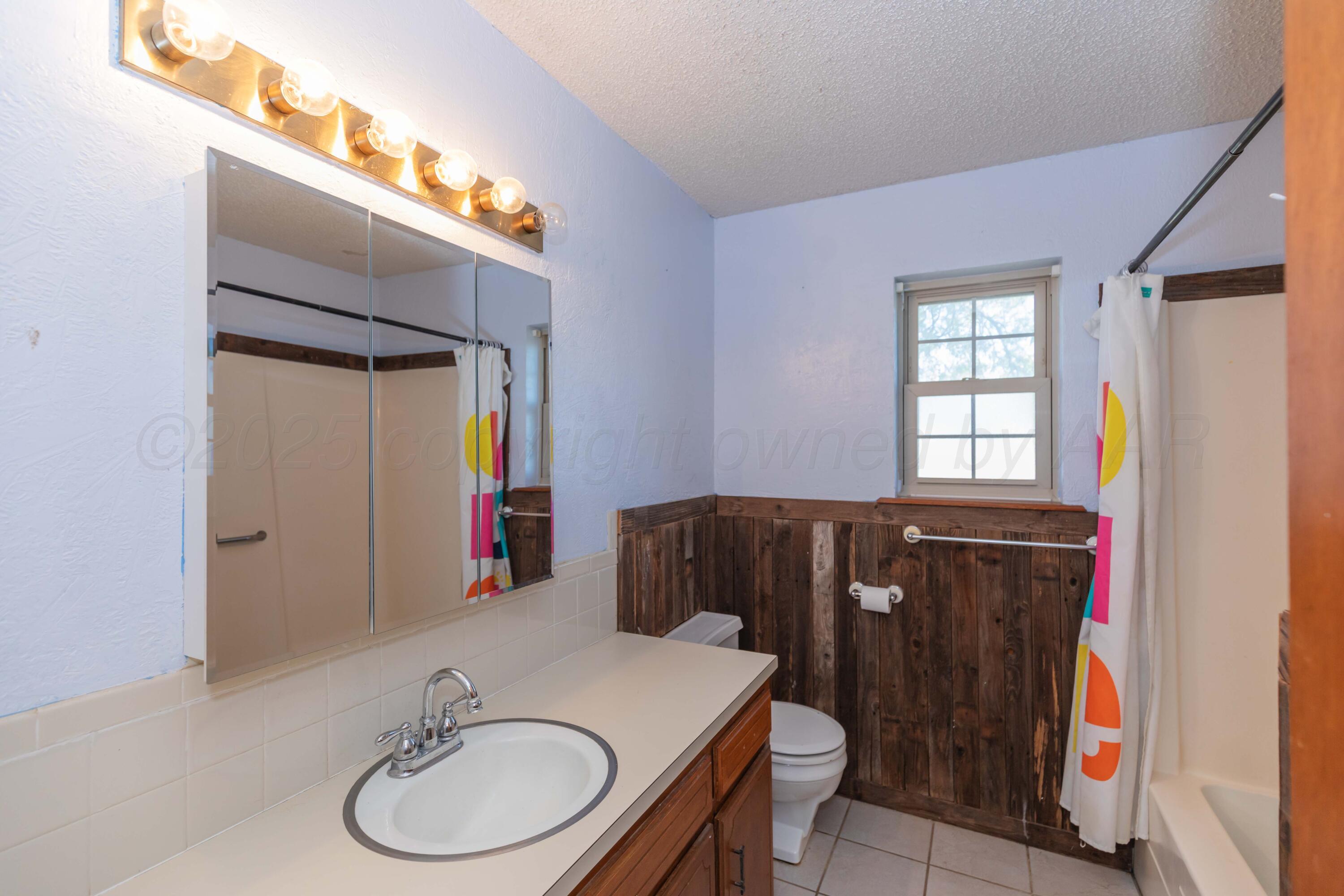 134 Eddie Street Canadian, TX 79014 - Photo 27 of 45 a bathroom with a sink vanity granite and a mirror