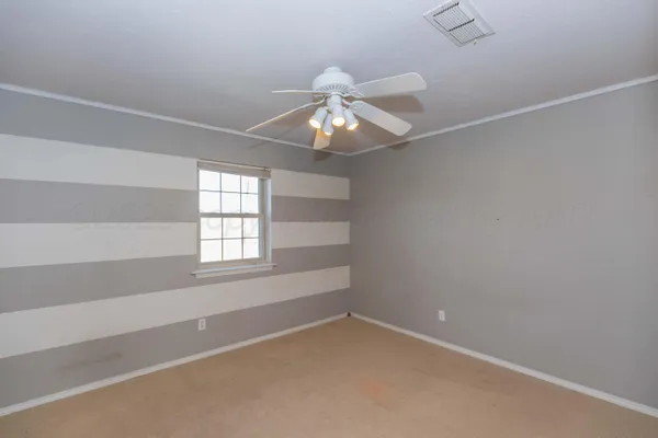 en empty room with a fan