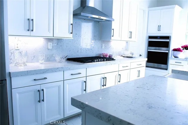 a kitchen with a potted plant on the counter and cabinets