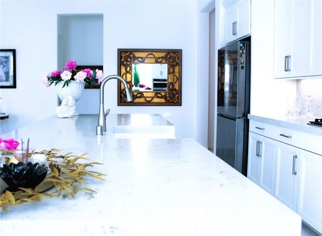 a kitchen with stainless steel appliances a stove a microwave and cabinets