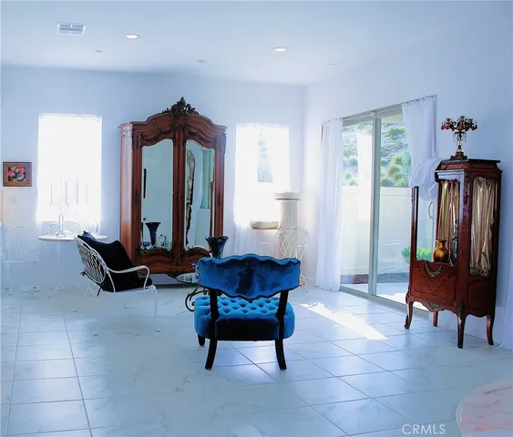 a bedroom with a large bed and a potted plant