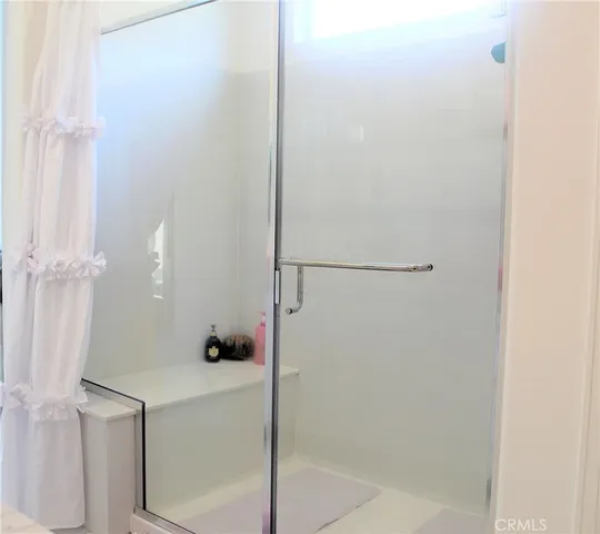 a white toilet sitting next to a bathroom sink and tub