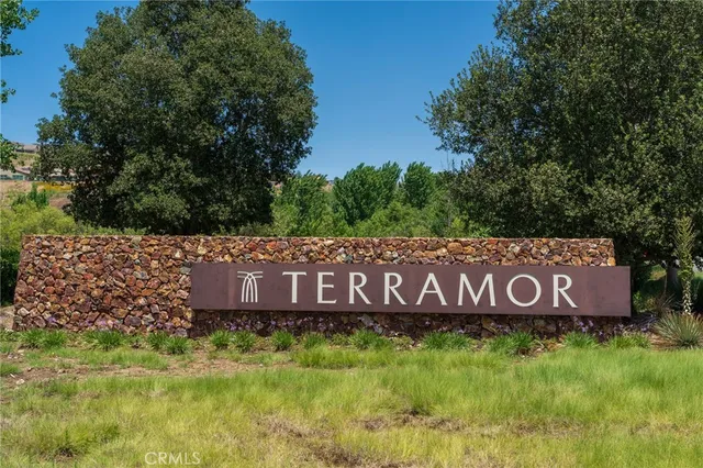 a sign that is sitting on a wooden fence