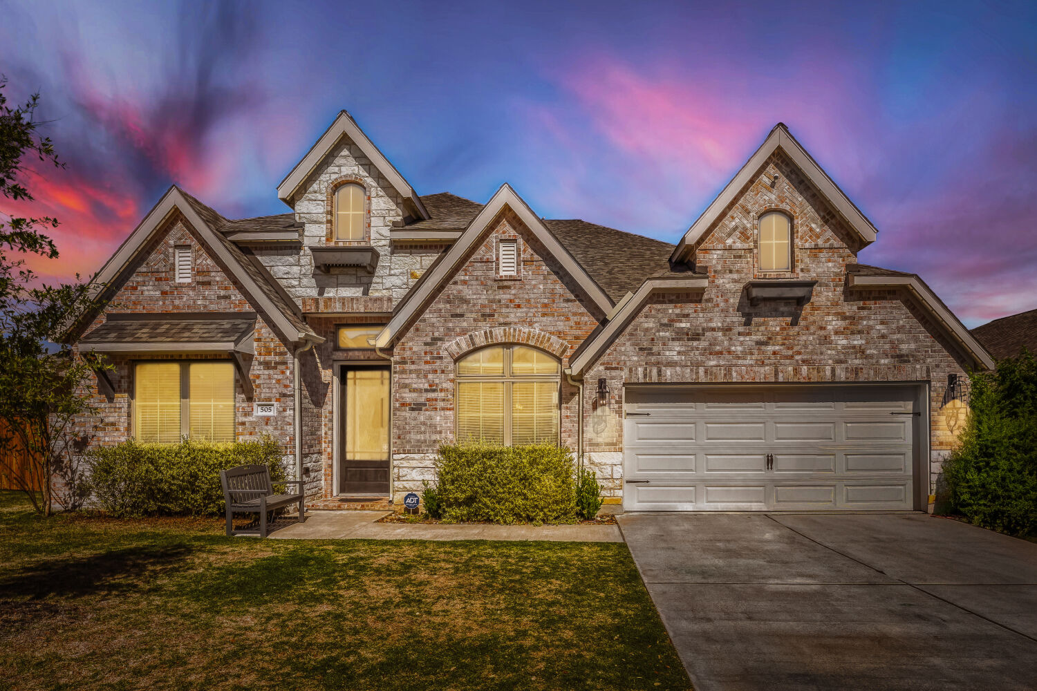 505 Trout River Road Kyle, TX 78640 - Photo 1 of 29 View of front of property featuring driveway, brick siding, a lawn, and roof with shingles