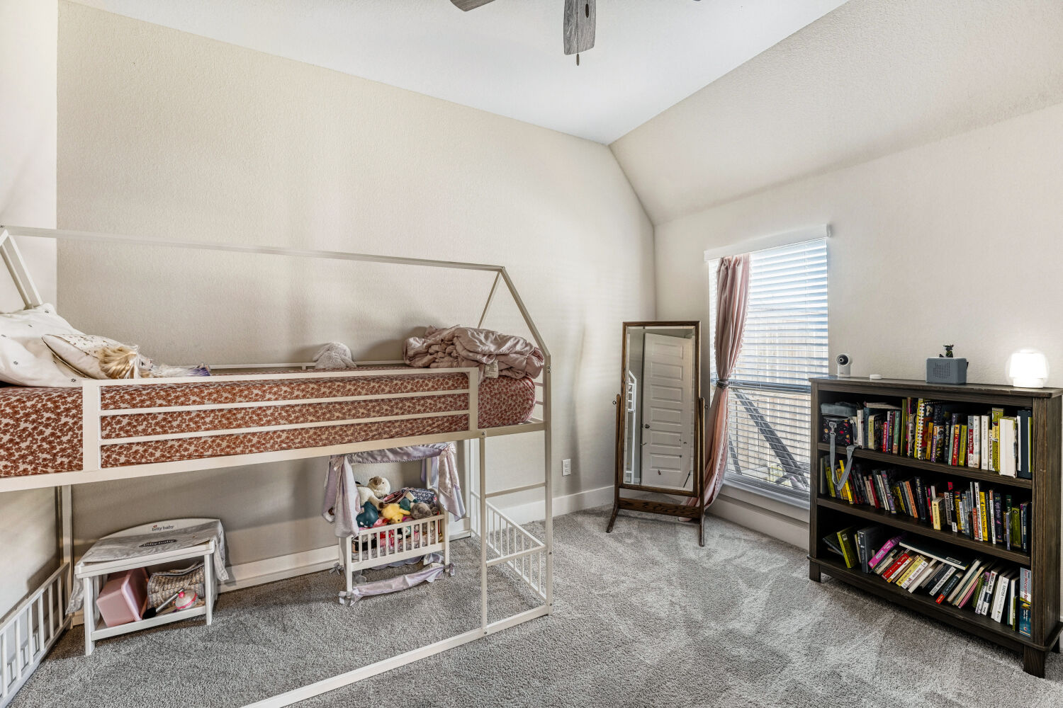 505 Trout River Road Kyle, TX 78640 - Photo 16 of 29 Bedroom with lofted ceiling, light carpet, and ceiling fan