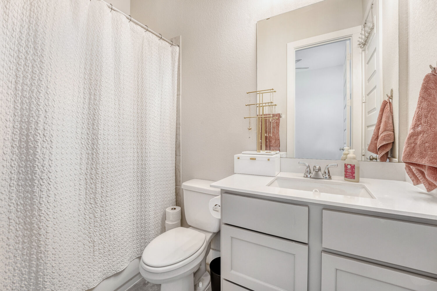 505 Trout River Road Kyle, TX 78640 - Photo 20 of 29 Bathroom with a shower with curtain, vanity, and a textured wall