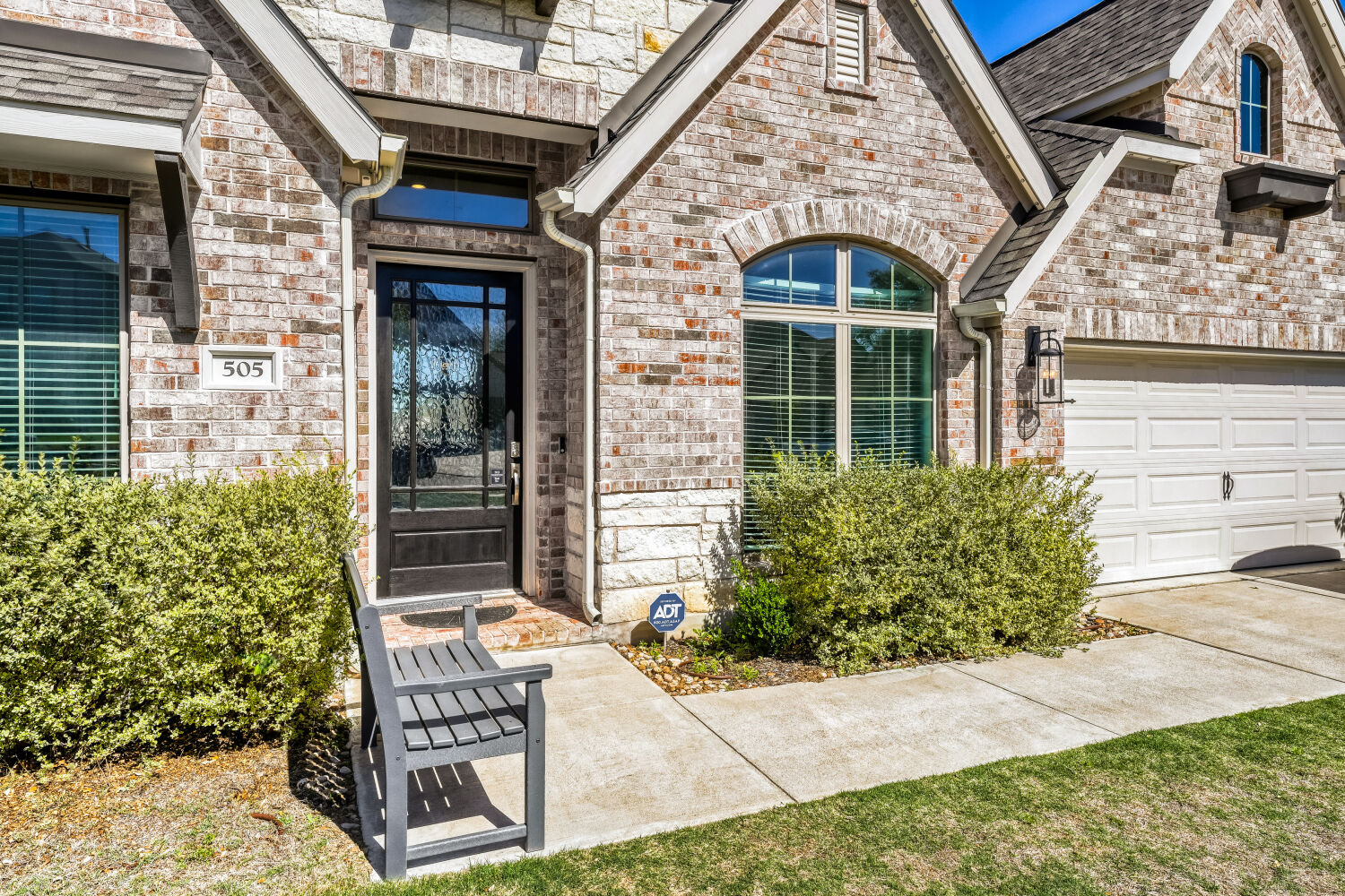 505 Trout River Road Kyle, TX 78640 - Photo 2 of 29 Entrance to property with a garage, brick siding, and driveway