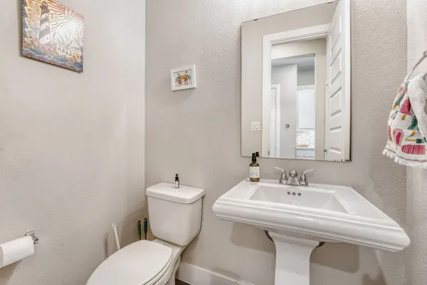 a bathroom with a toilet sink and mirror