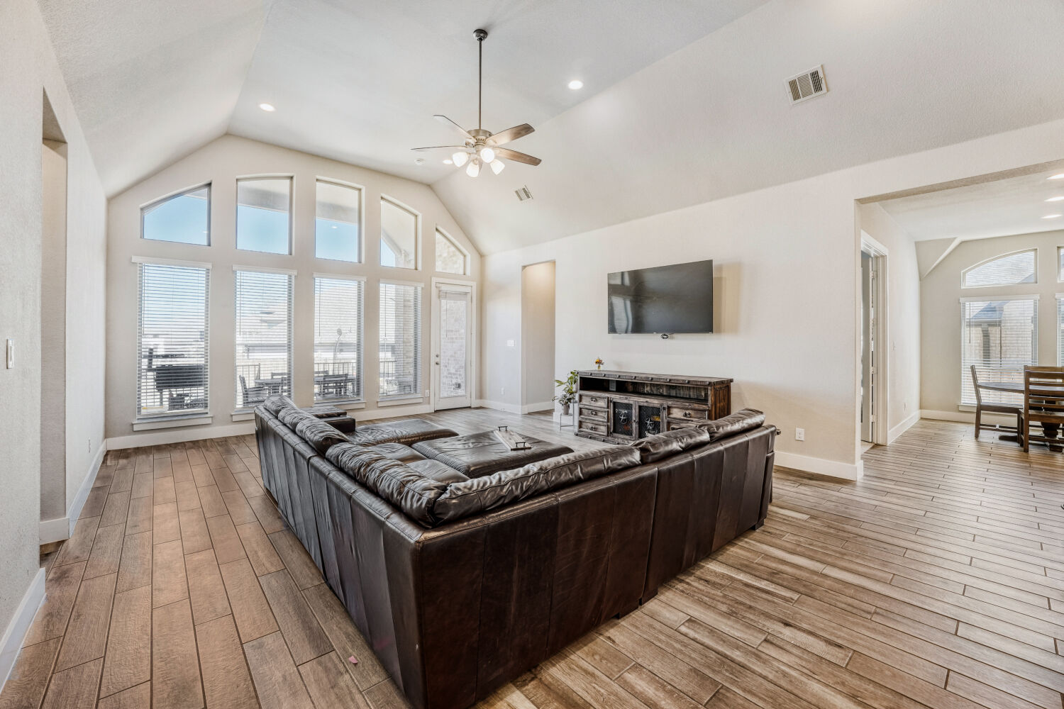 505 Trout River Road Kyle, TX 78640 - Photo 4 of 29 Living room with a ceiling fan, healthy amount of natural light, light wood-type flooring, recessed lighting, and a high ceiling