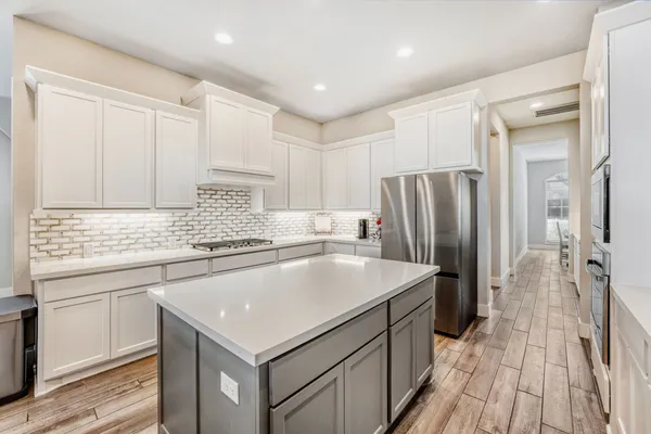 a kitchen with a sink stove and refrigerator
