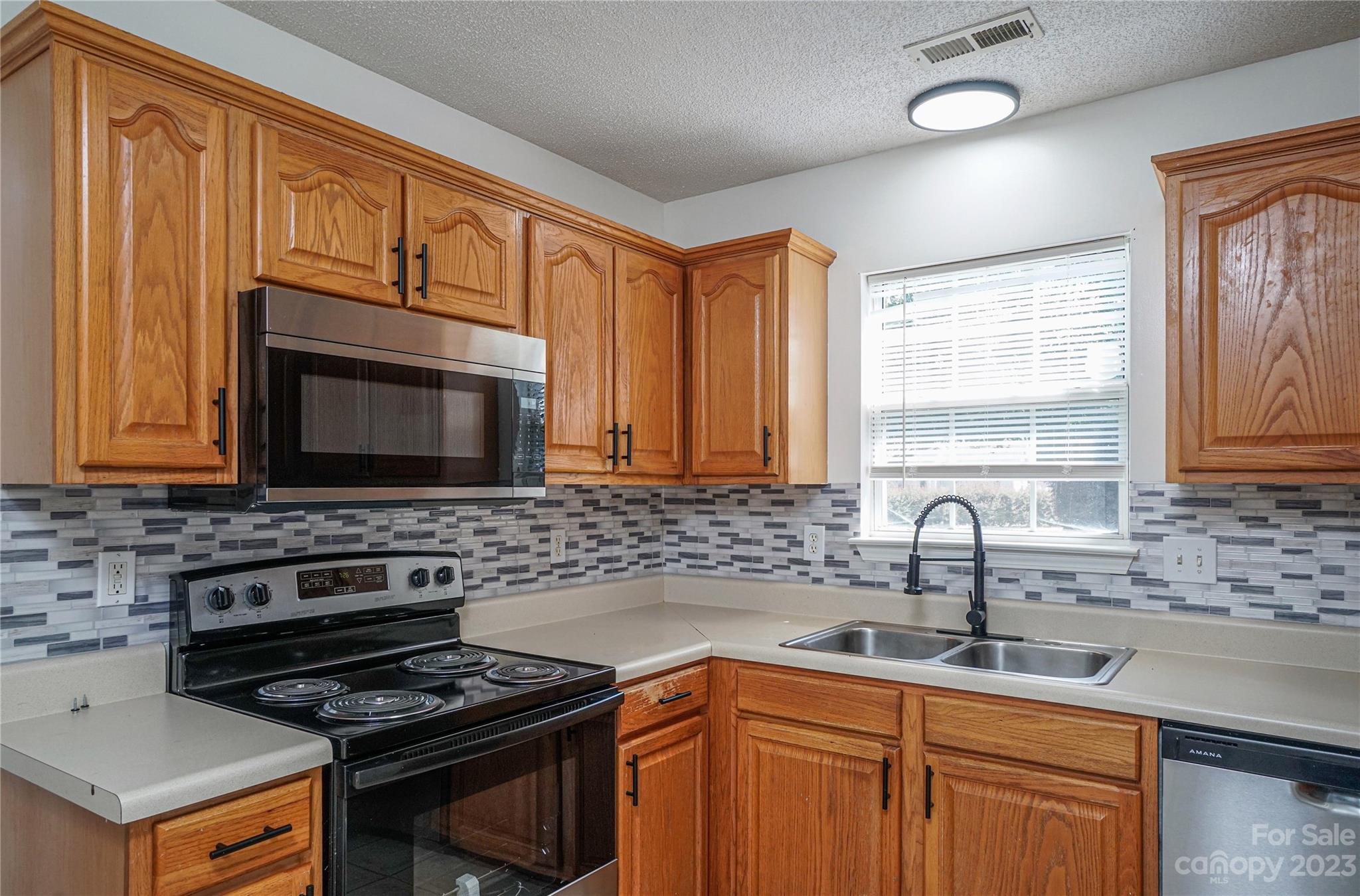 520 Jacobs Ridge Fort Mill, SC 29715 - Photo 11 of 33 a kitchen with a stove a sink and a microwave