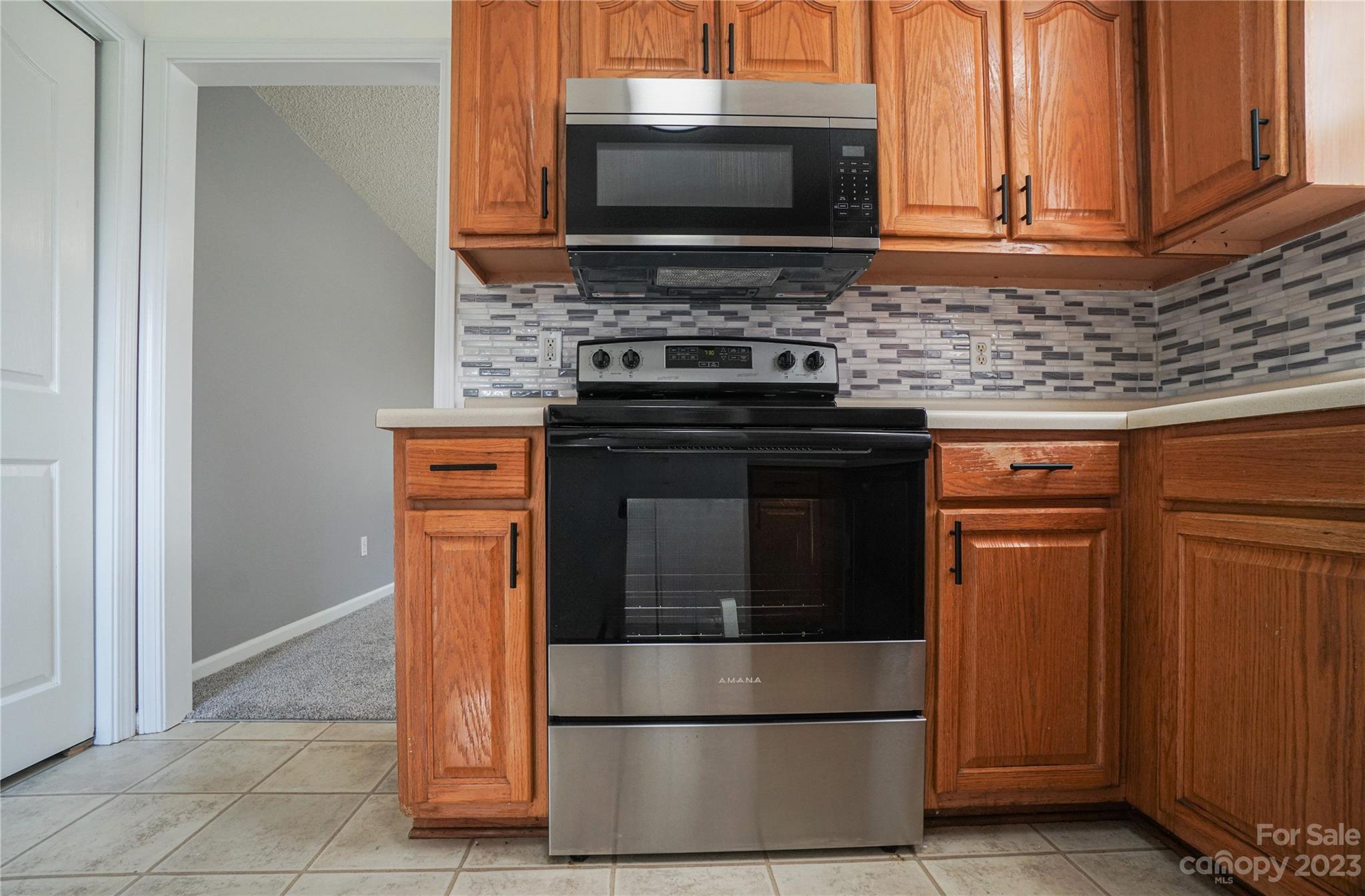 520 Jacobs Ridge Fort Mill, SC 29715 - Photo 15 of 33 a kitchen with stainless steel appliances granite countertop a stove microwave and oven