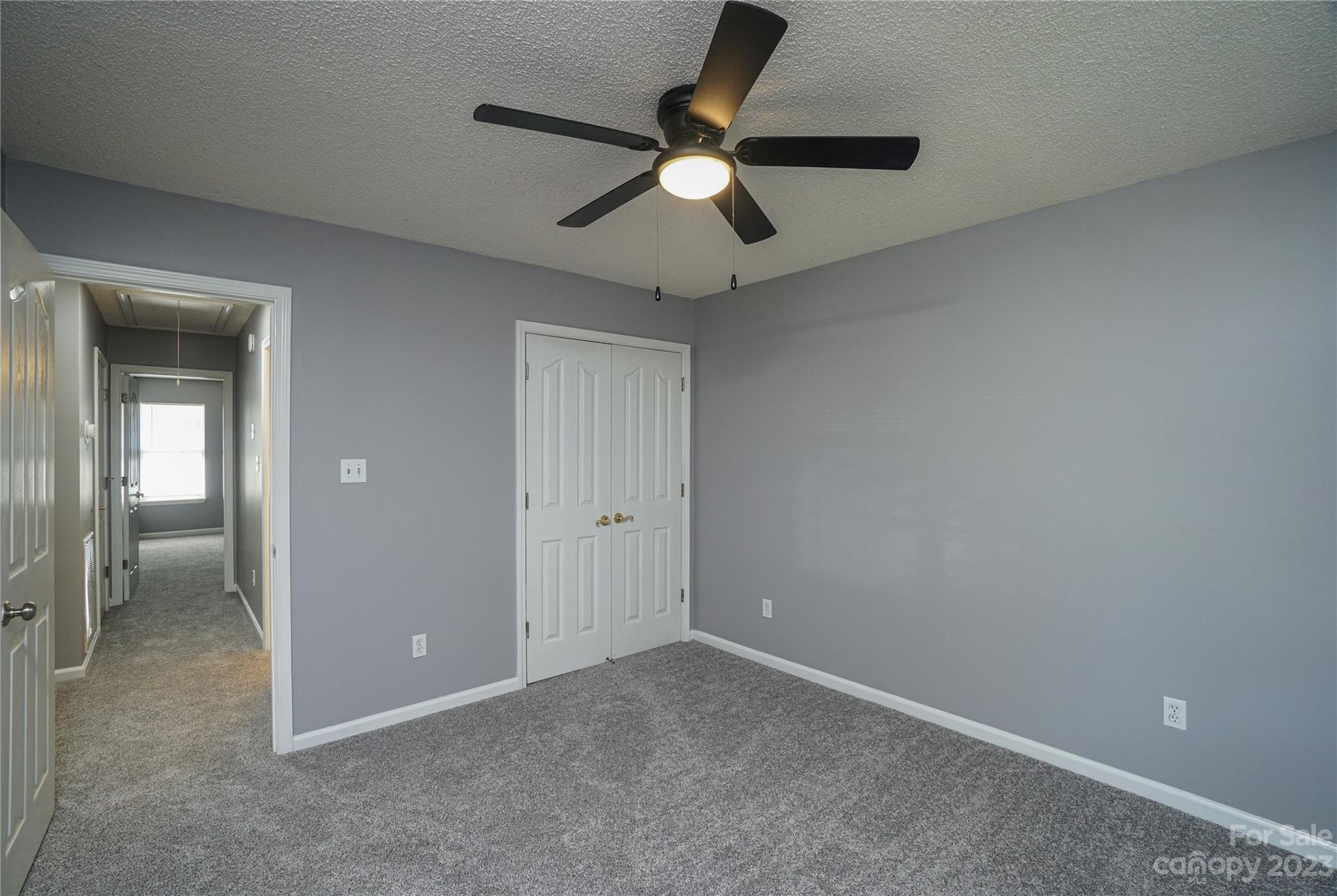 520 Jacobs Ridge Fort Mill, SC 29715 - Photo 24 of 33 an empty room with closet and a chandelier fan