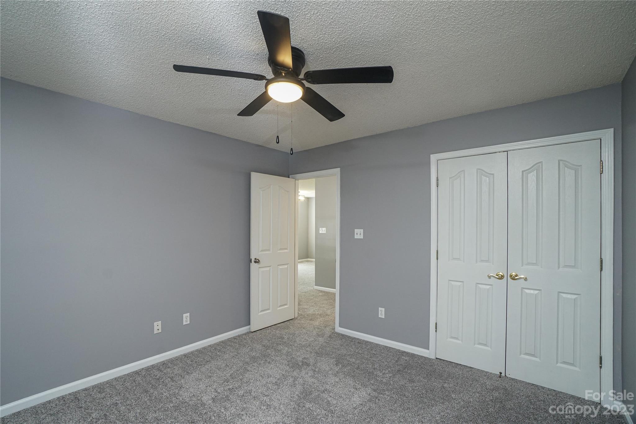 520 Jacobs Ridge Fort Mill, SC 29715 - Photo 25 of 33 an empty room with closet and a chandelier fan
