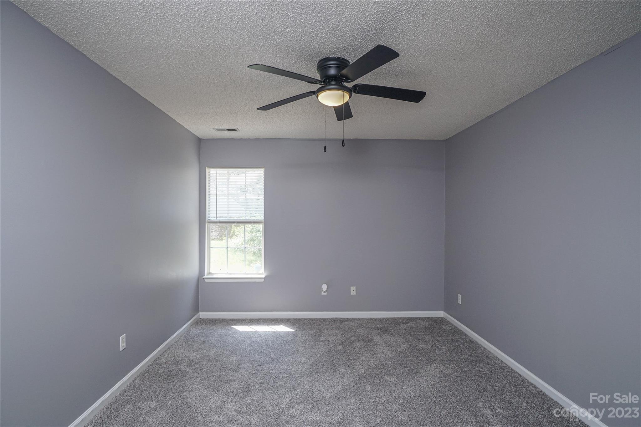 520 Jacobs Ridge Fort Mill, SC 29715 - Photo 32 of 33 an empty room with window and ceiling fan