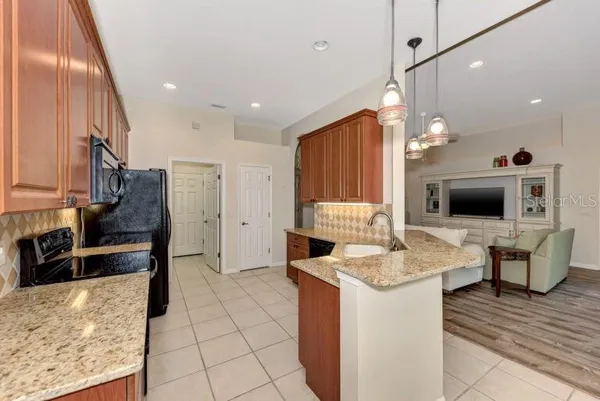 a kitchen with a sink stove and refrigerator
