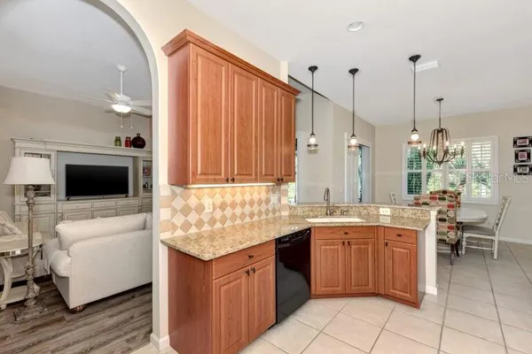a kitchen with stainless steel appliances granite countertop a sink and a stove