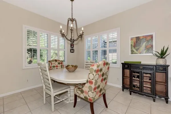 a view of a dining room with furniture and chandelier
