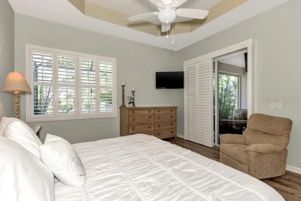 a bedroom with a bed and a television