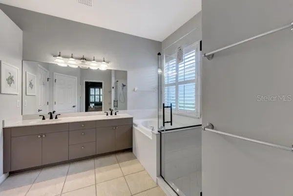 a large bathroom with a double vanity sink mirror and shower
