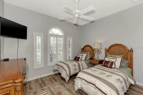 a bedroom with two beds and a flat screen tv
