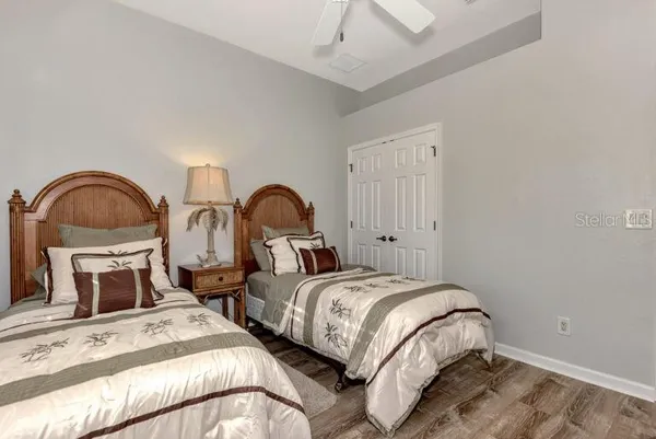 a bedroom with two beds and painting on the wall