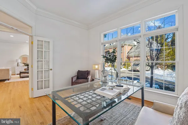 a kitchen with stainless steel appliances kitchen island granite countertop a refrigerator a stove a sink dishwasher and a dining table with wooden floor