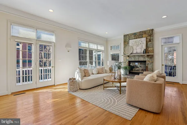 a living room with furniture and a floor to ceiling window