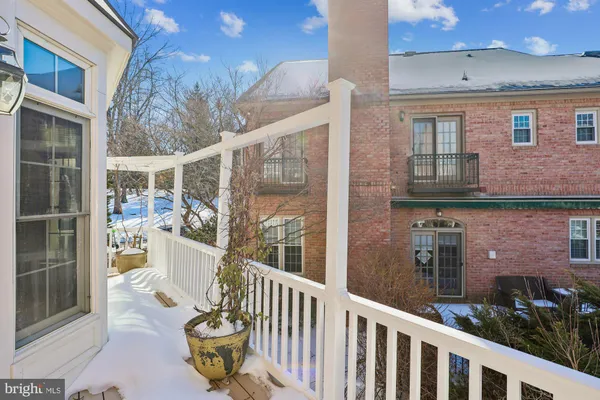 a spacious bedroom with a bed and a chandelier
