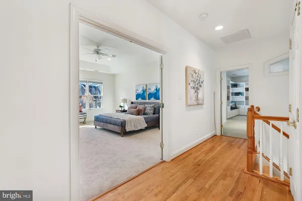 a bathroom with a granite countertop sink a toilet a mirror and bathtub