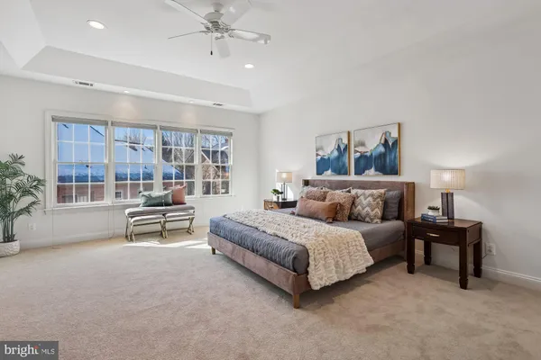a spacious bathroom with double vanity sinks a large mirror and a shower