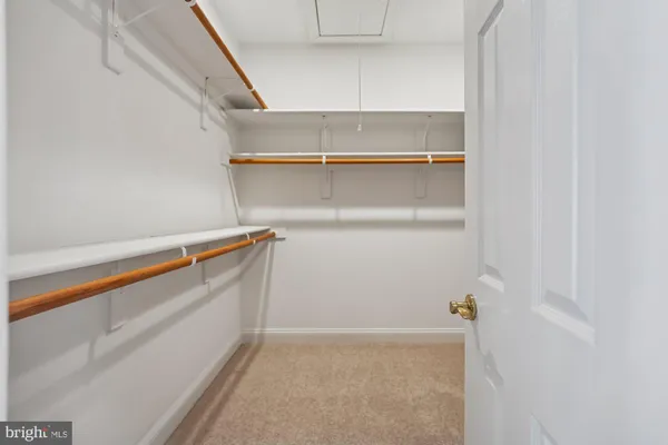 a living room with furniture cabinets and kitchen view