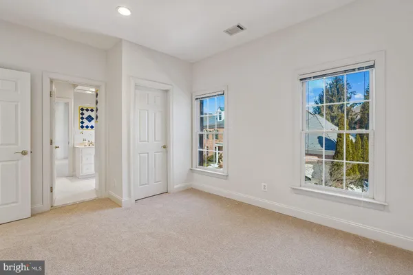 a front view of a house with a yard and fountain