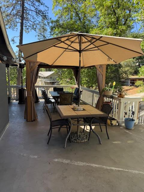 5827 Lookout Court Murphys, CA 95247 - Photo 16 of 21 a view of patio with table and chairs under an umbrella