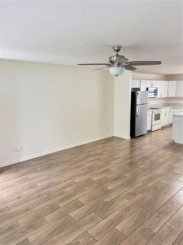 a view of a kitchen with microwave and a ceiling fan