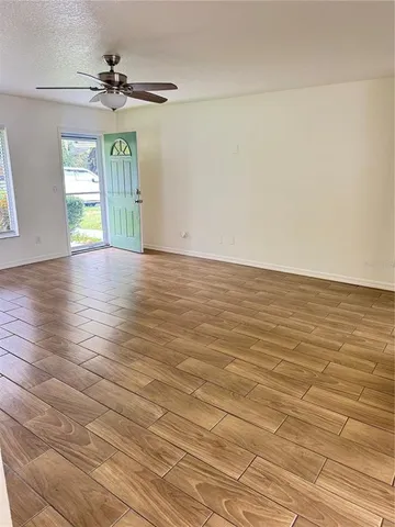 wooden floor in an empty room with a window