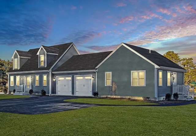 a front view of a house with a garden