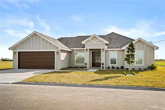 a view of a house with a swimming pool and sitting area