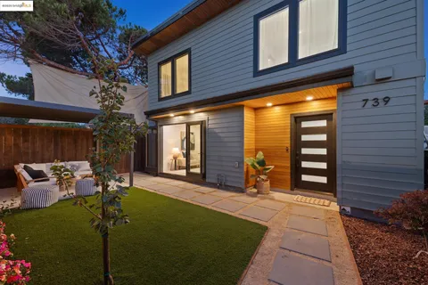 a view of a patio with table and chairs and potted plants