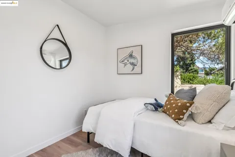 a bedroom with bed and glass door