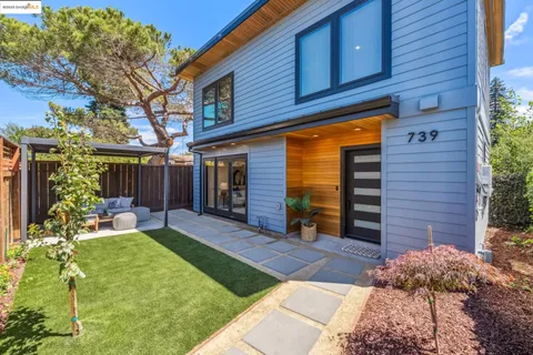 a view of a house with a yard and sitting area