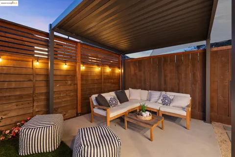 a balcony with furniture and a garden
