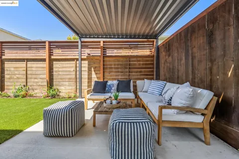 a view of a patio with couches chairs and potted plants