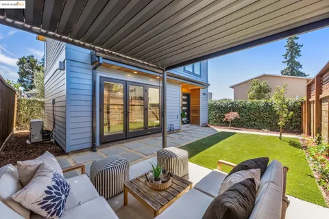 a outdoor living space with furniture and a rug