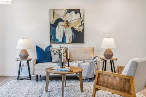 a living room with furniture and view of kitchen