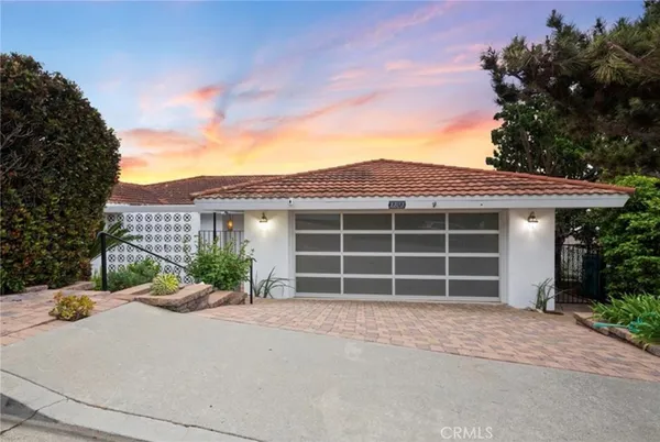 a front view of a house with a yard and a garage