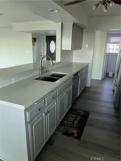 a kitchen with sink stove and cabinets