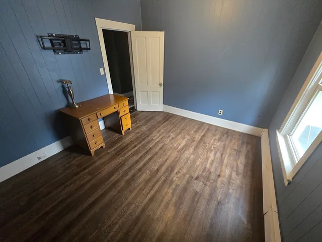 a room with wooden floor and furniture